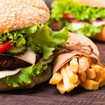 Handmade cheeseburger with tomato , cucumber and lettuce